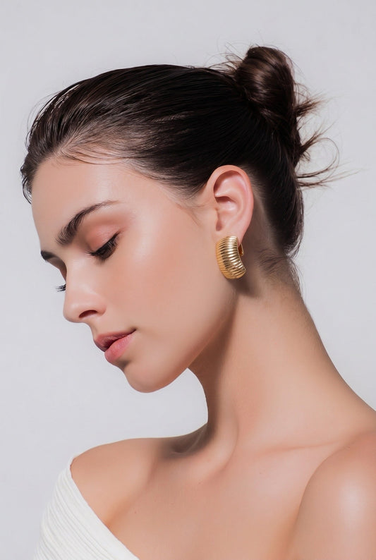 14K gold drop earrings worn by woman, elegant teardrop shape with secure ear wires, Chrysus Golds