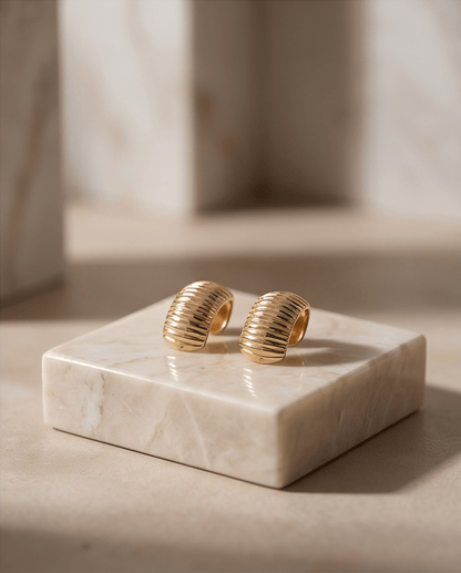 14K gold drop earrings with smooth polished finish on luxury display stand, Chrysus Golds
