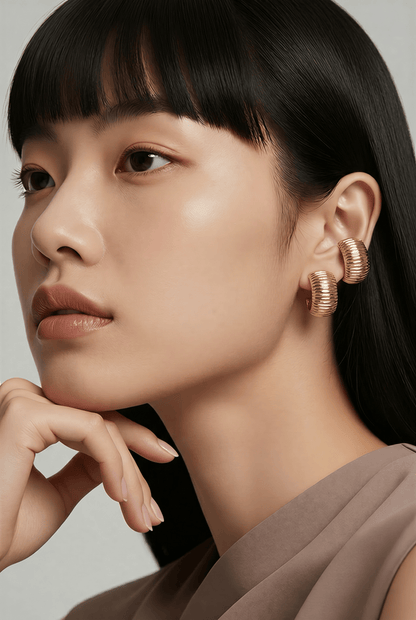 Woman wearing 14K gold drop earrings, featuring hypoallergenic posts and lightweight design, Chrysus Golds