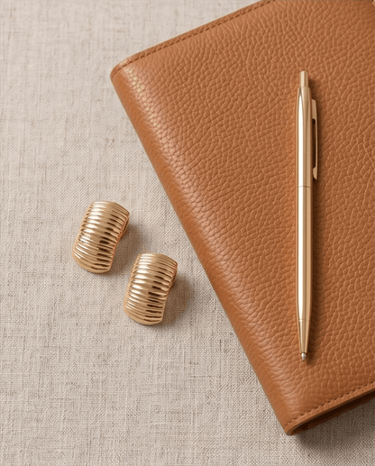 14K gold drop earrings displayed on textured brown background, luxury jewelery collection, Chrysus Golds